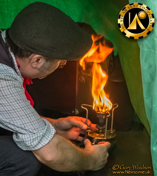 priming an old brass stove. The Steam Tent Co-operative.  Gary Waidson - www.Nemo.me.uk